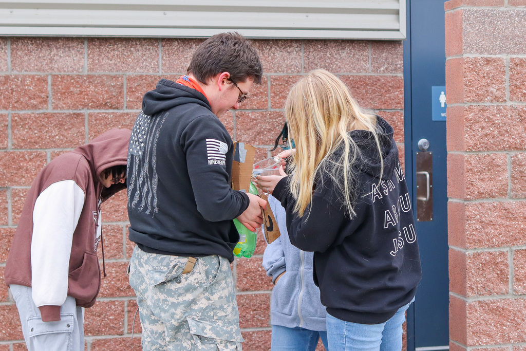 student filling rocket up with water