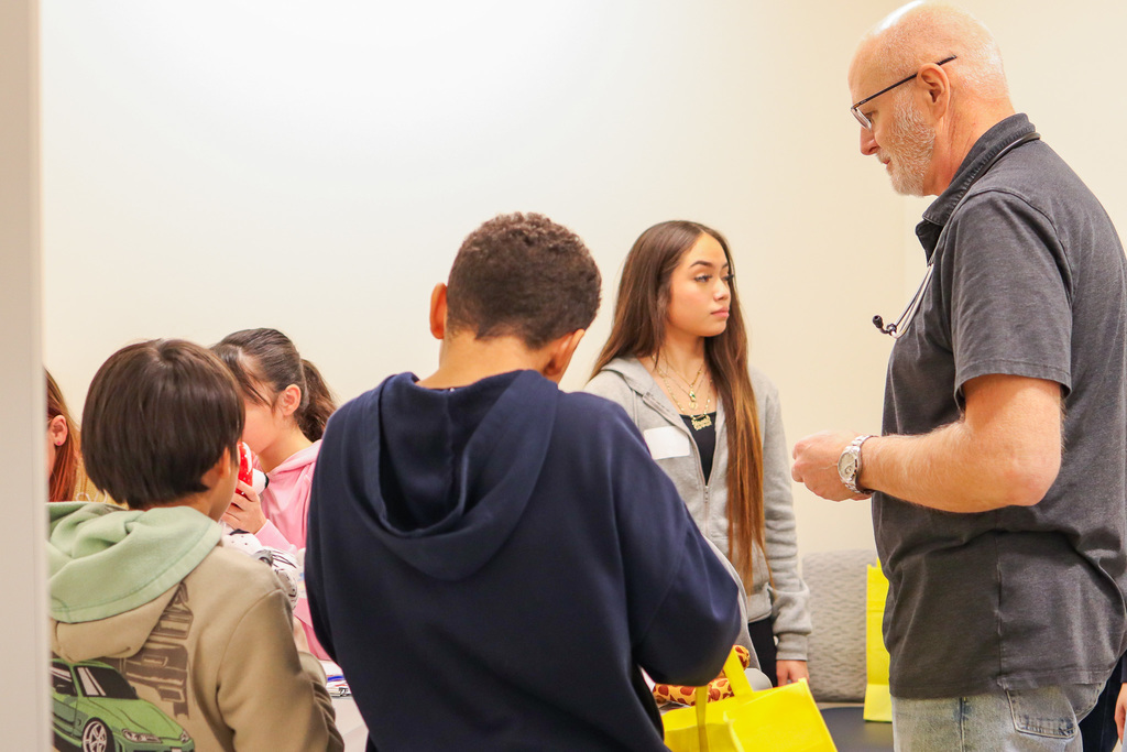 Dr. Earl showing students how to check ears of stuffed animal