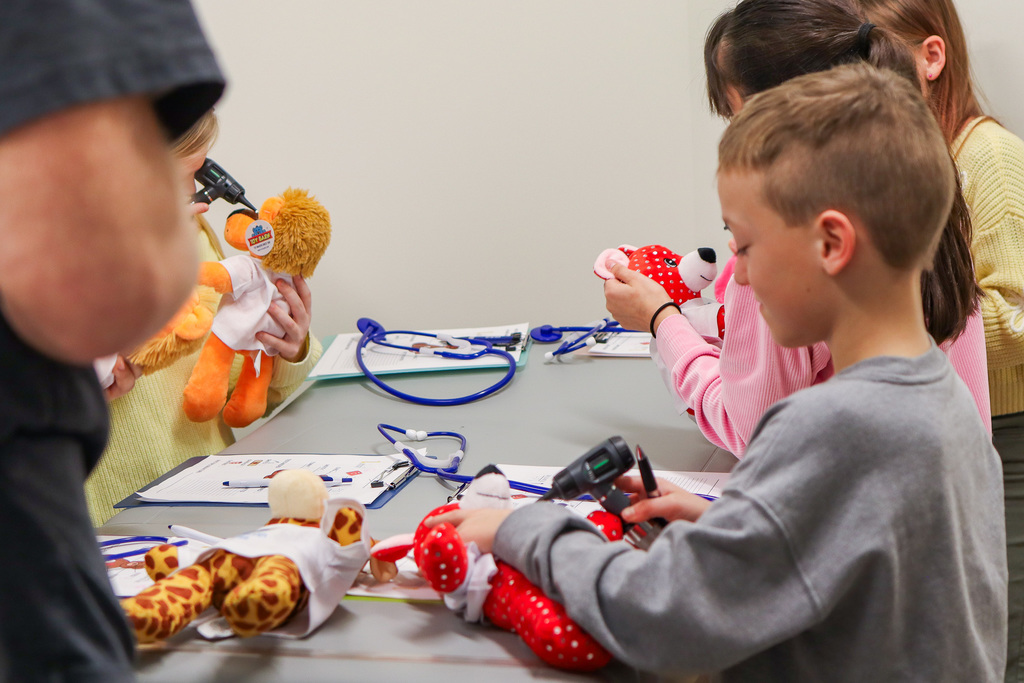 students checking the ears of their stuffed animal
