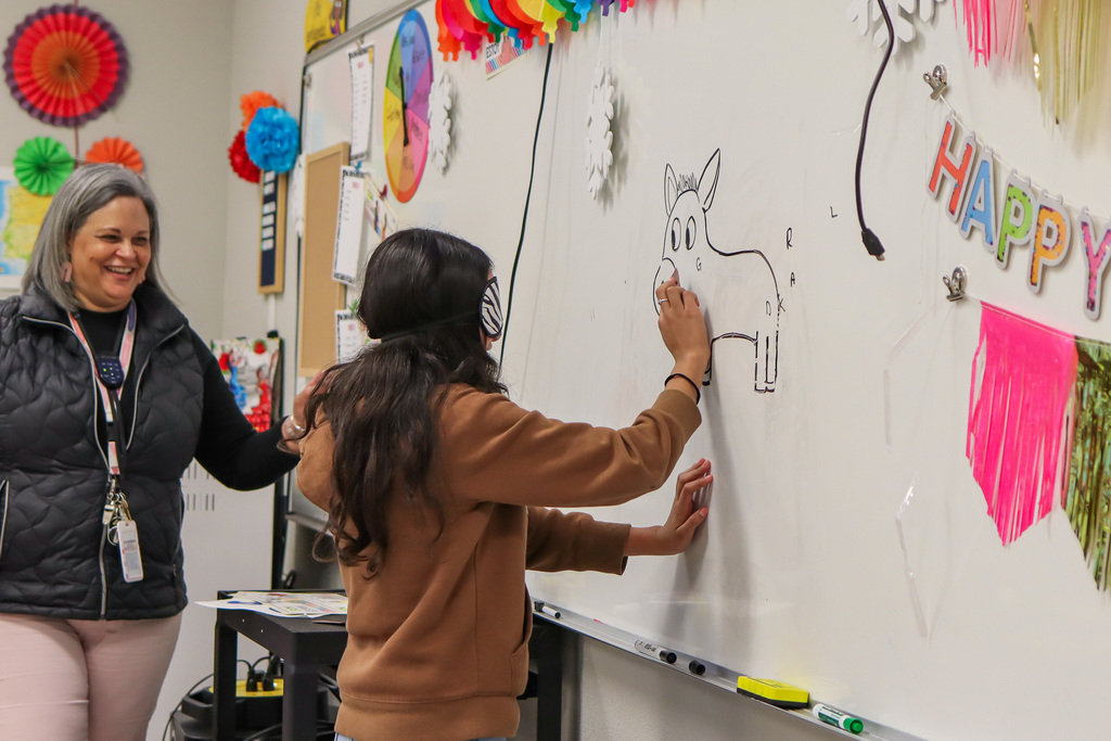 student playing pin the tail on the donkey 