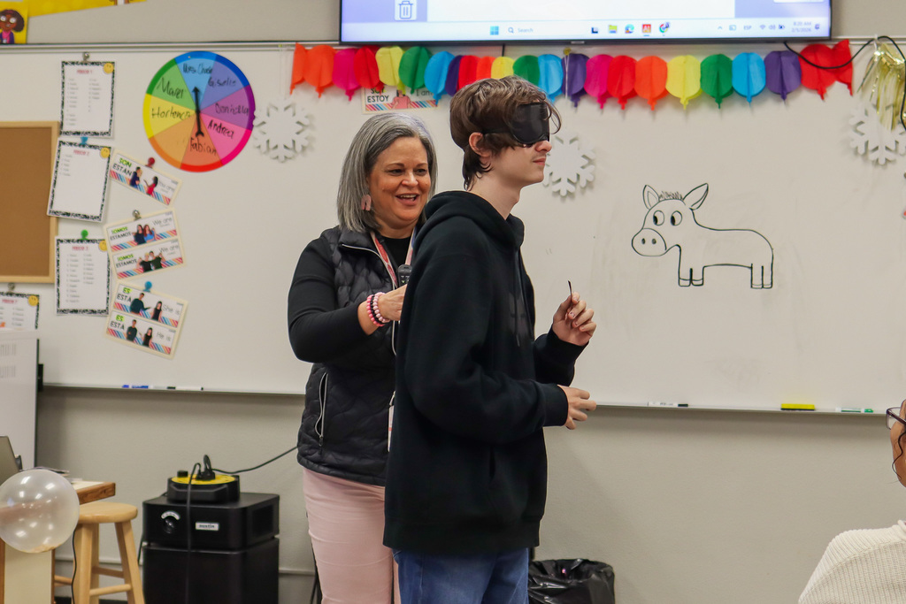 student playing pin the tail on the donkey 