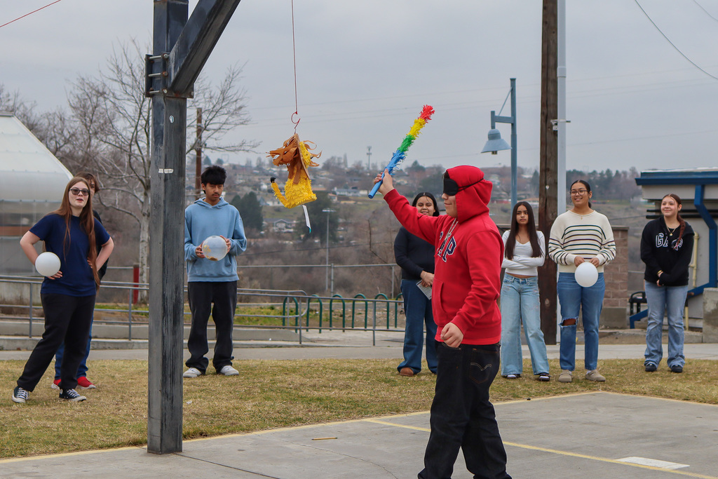 student trying to hit the piñata