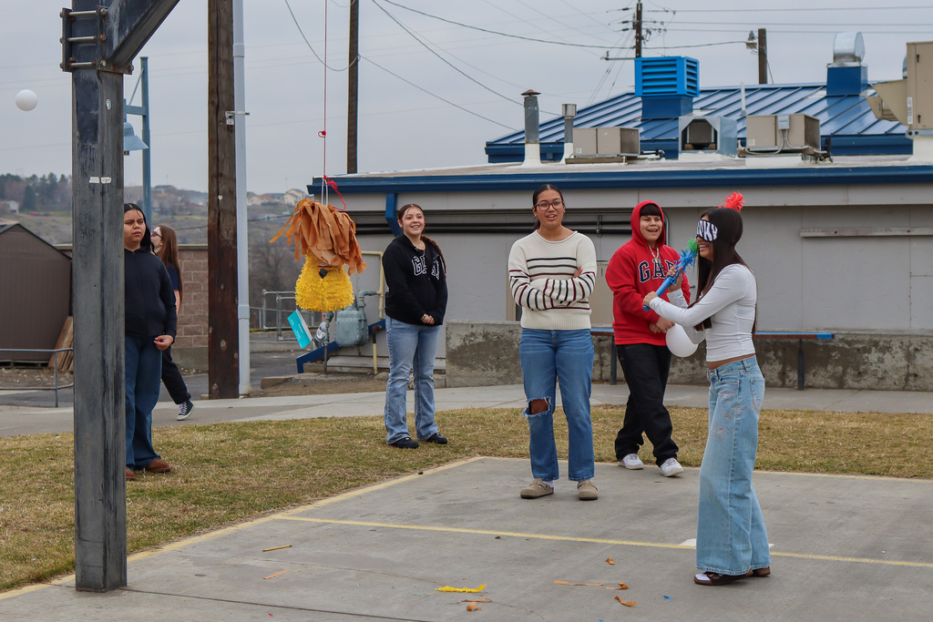 student trying to hit the piñata