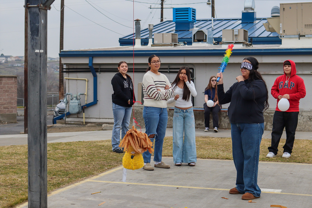 student trying to hit the piñata