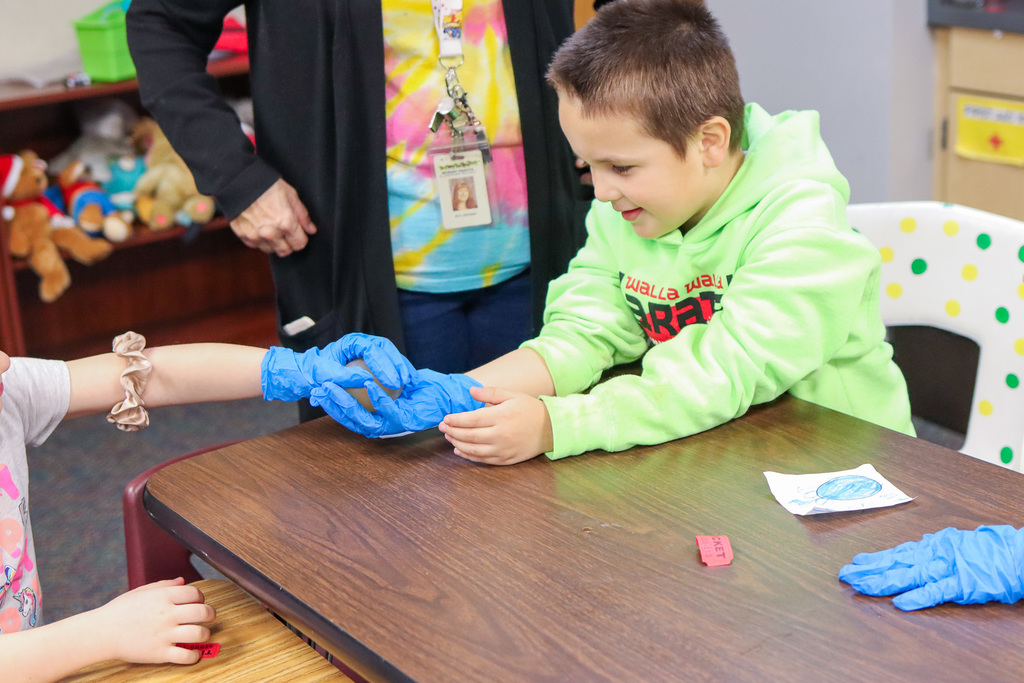 student getting to hold the vinegar egg