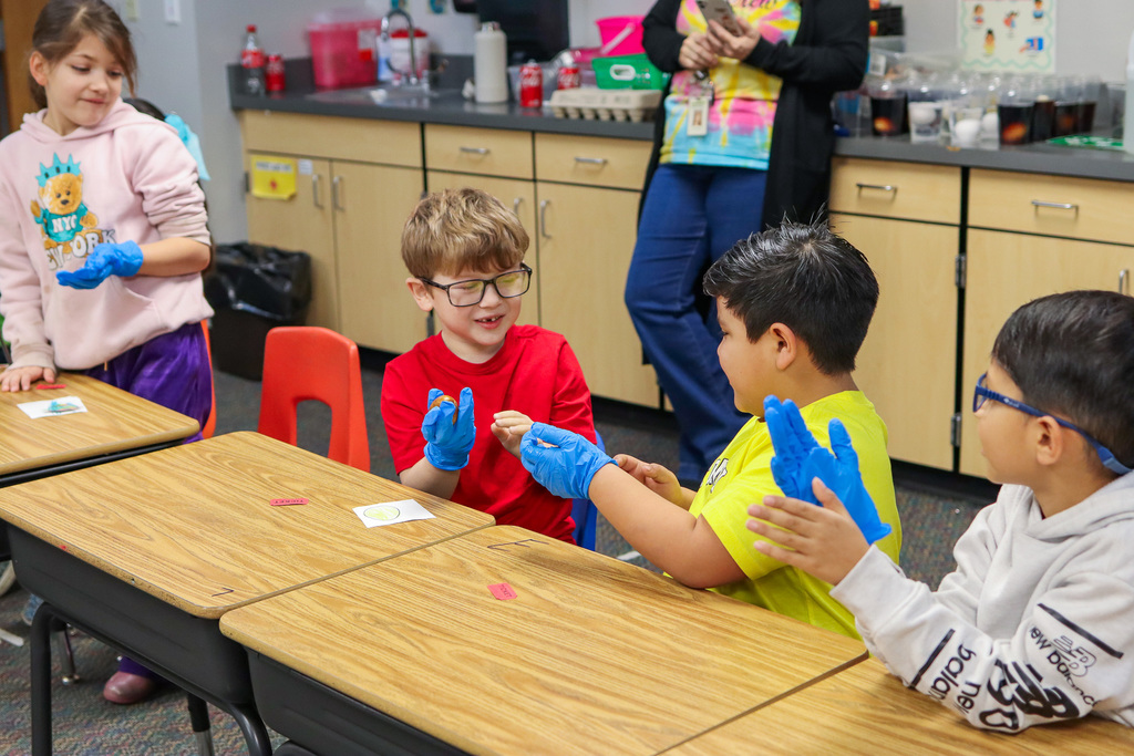 students getting to hold the coffee egg