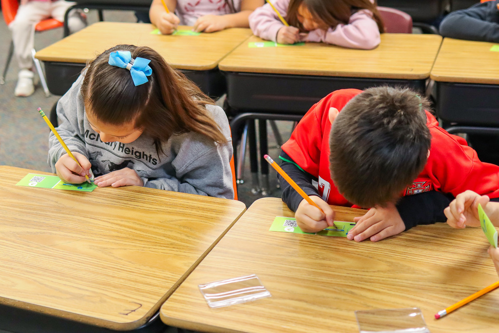 students filling out their badges 