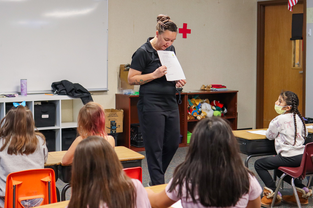 Mrs. Carrie explaining the event plan to students 