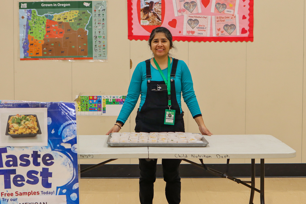 Photo of Nutrition Educator Lourdes at Taste Testing Table