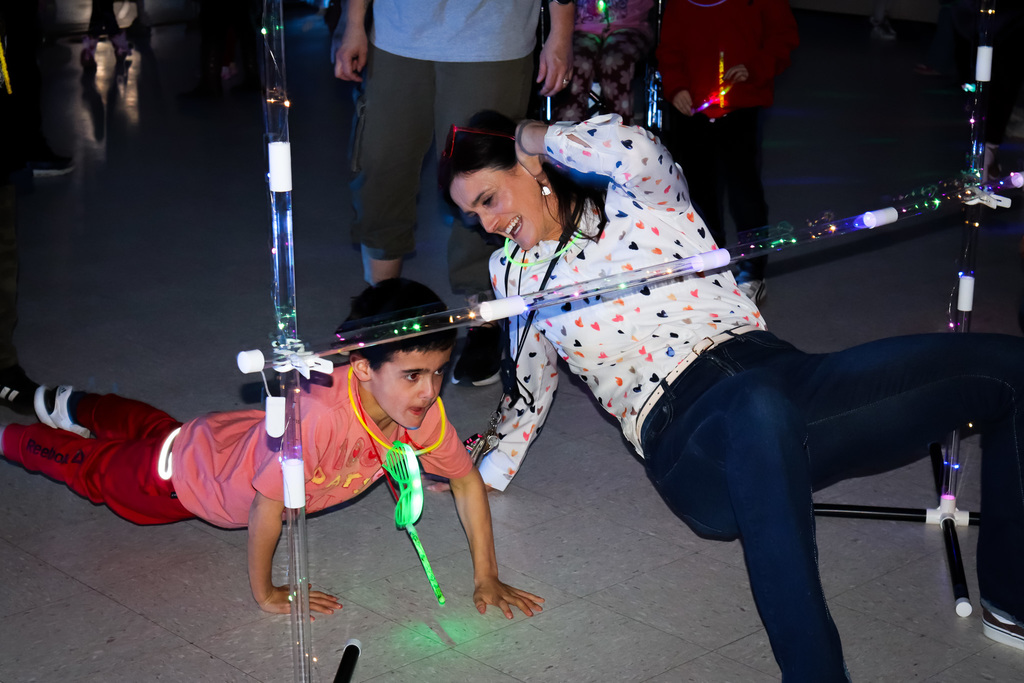 photo of student and teacher playing limbo