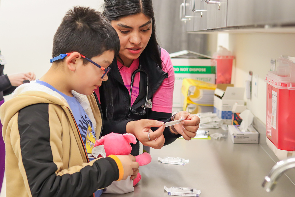 Nurse showing student how to properly open a band aid 