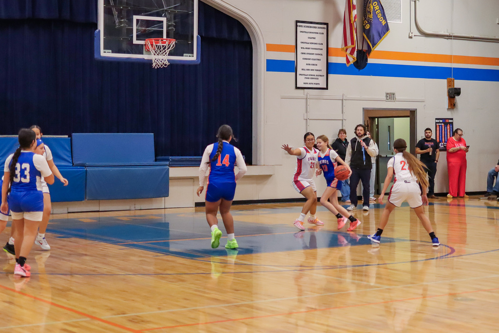 Girls teams playing basketball against each other