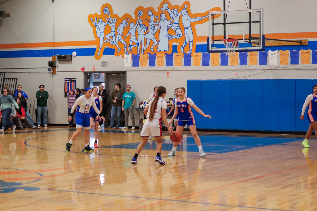 Girls teams playing basketball against each other