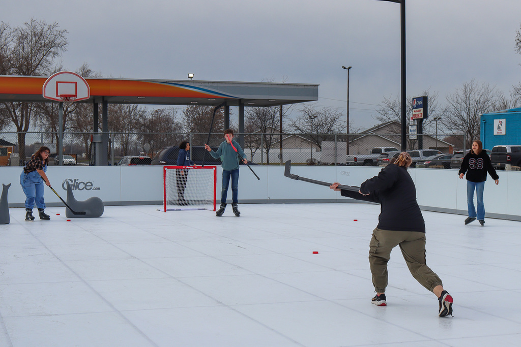 students playing hockey on the rink