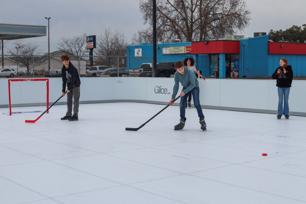 students playing hockey on the rink
