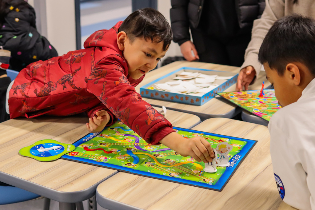students playing the board game ladders 