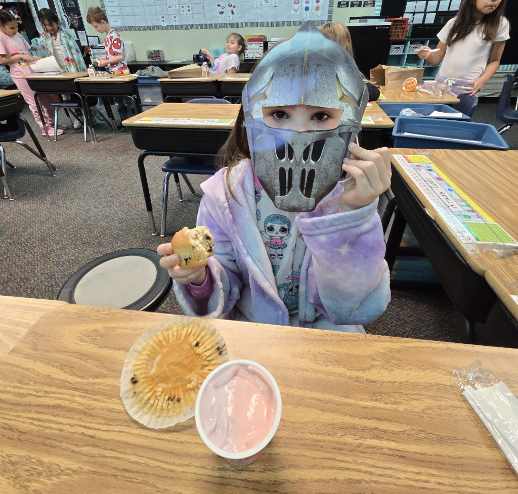 student enjoying their breakfast and dressed as a knight 