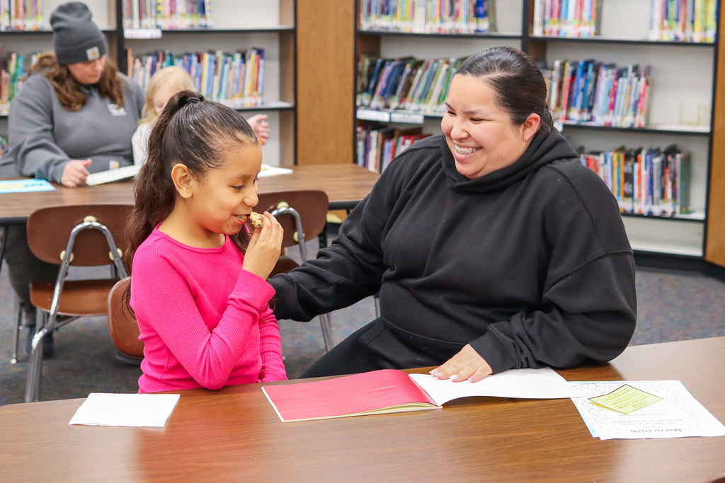 A student and family enjoying the snacks provided at the event 