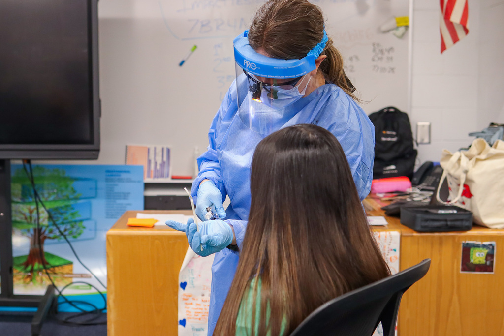 Dental hygienist showing student the temporary filling product