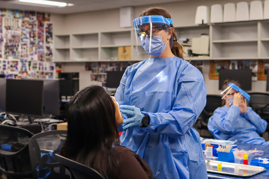 Photo of dental hygienist working on student's teeth 