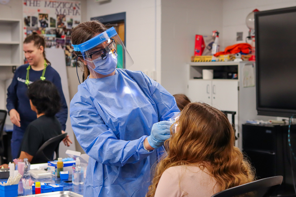 Photo of dental hygienist working on student's teeth 