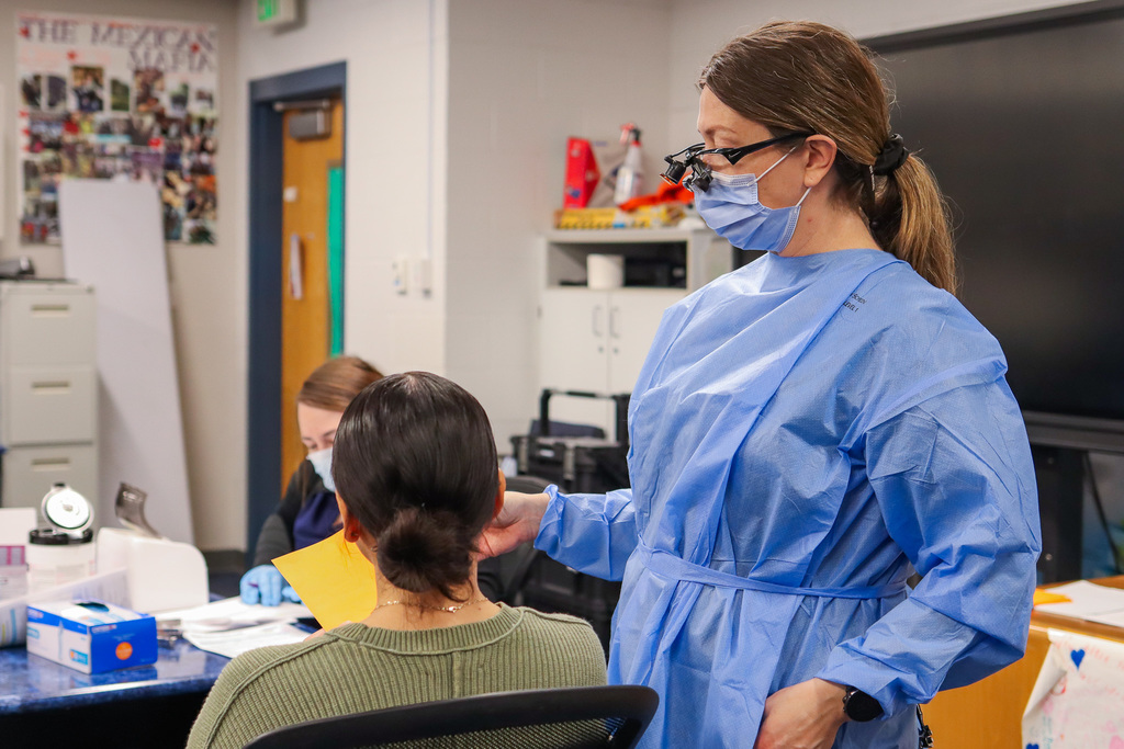 Photo of dental hygienist working on student's teeth 