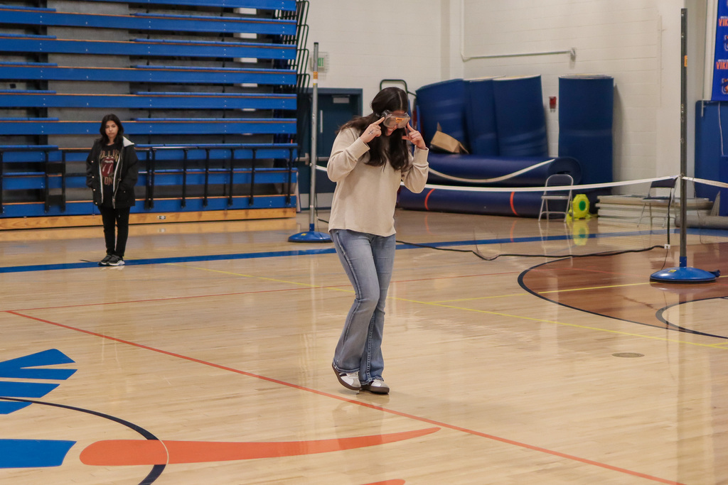 student walking with the impairment goggles 