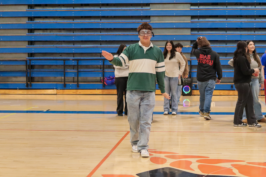 student trying to maintain their balance with the impairment goggles 