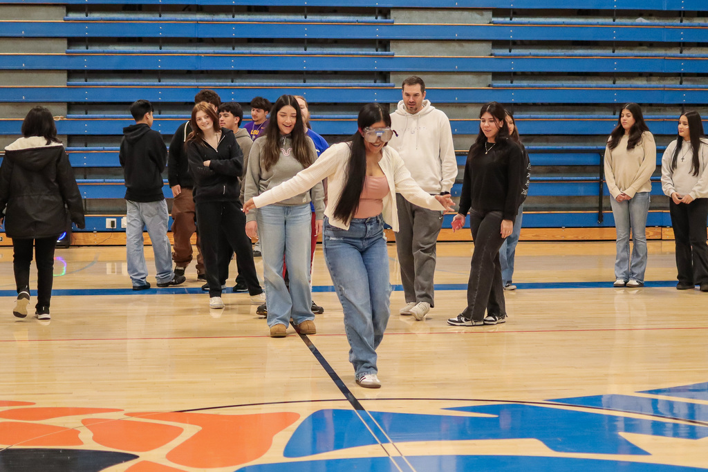 student walking with the impairment goggles 