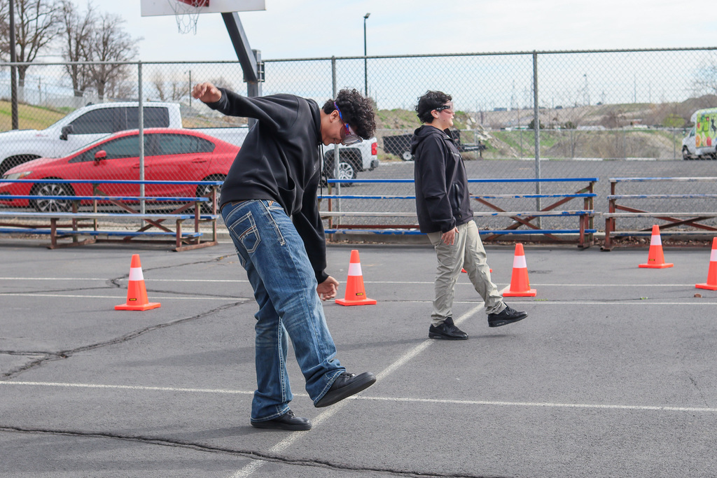 students trying to maintain their balance with the impairment goggles 