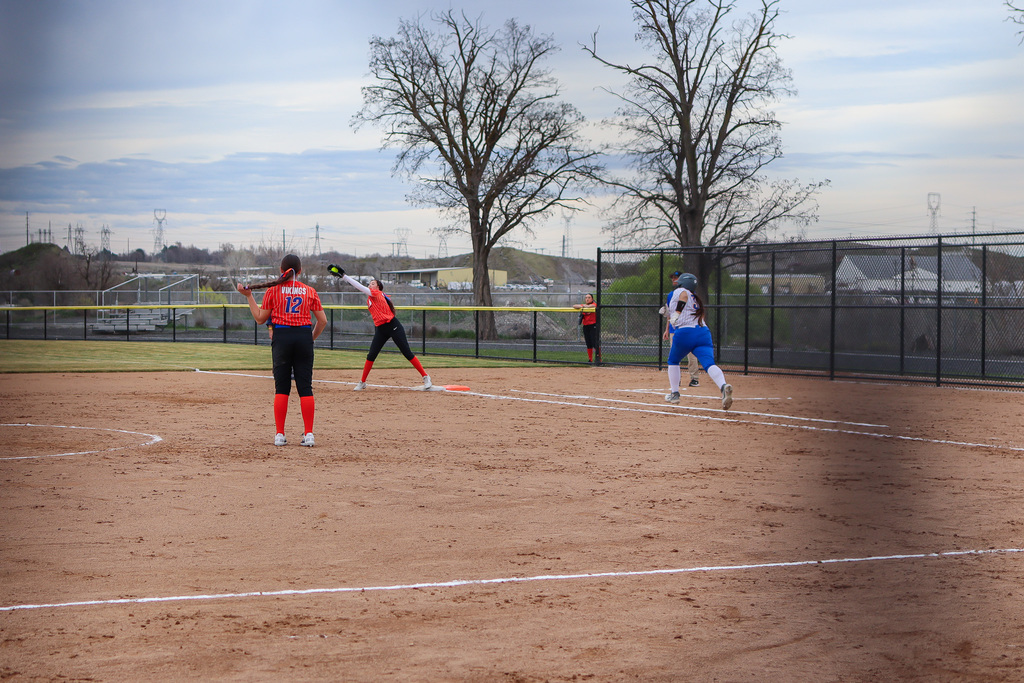 UHS player catching the ball as opponent races to first base 