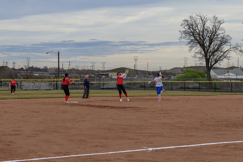 UHS player catching the ball as opponent races to second base 