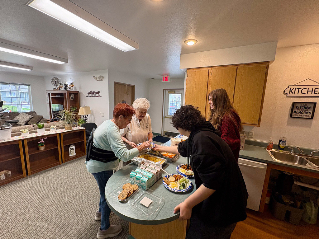 UHS students helping serve senior residents their meals 