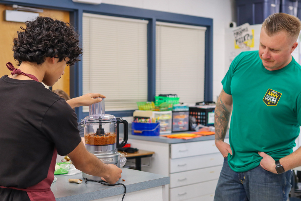 student blending sauce for pizza 