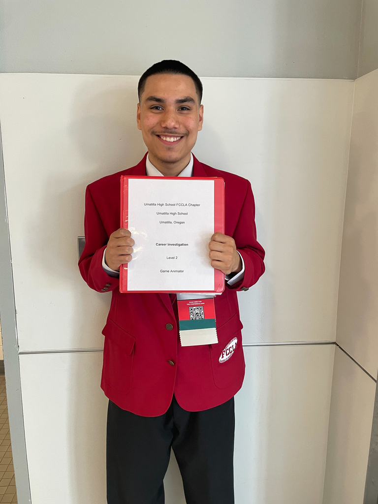 Sophomore Eduardo with his Career Investigation Binder 