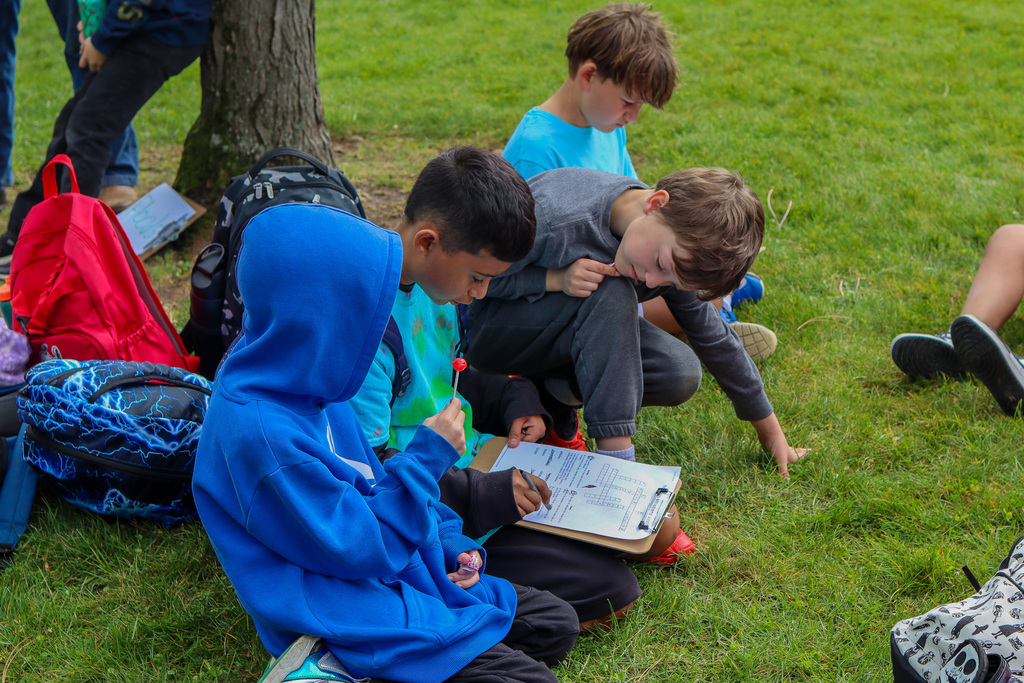 Students filling out cross word puzzle 