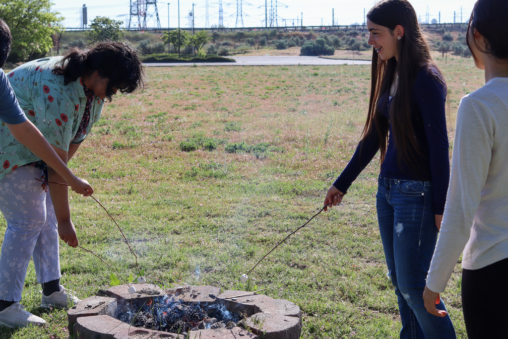 Students roasting marshmallows 