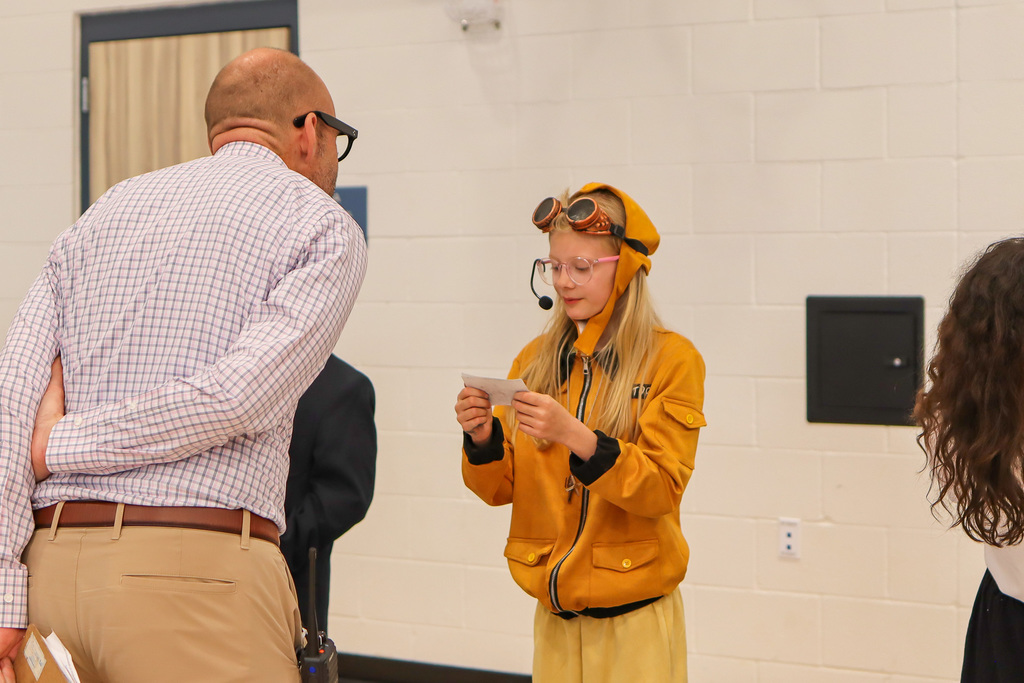 student presenting speech to Principal Mr. Young 