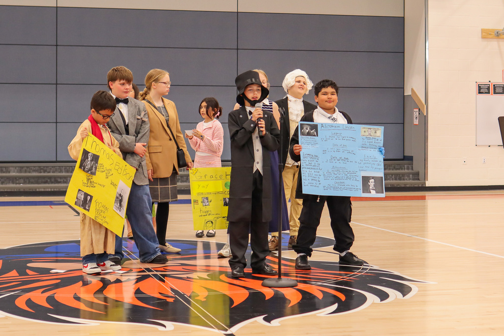 Student presenting their speech to entire 4th and 5th grade class