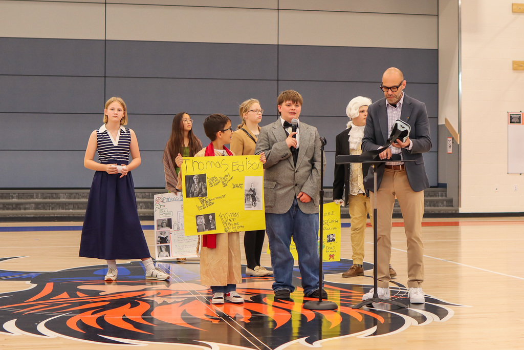 Student presenting their speech to entire 4th and 5th grade class