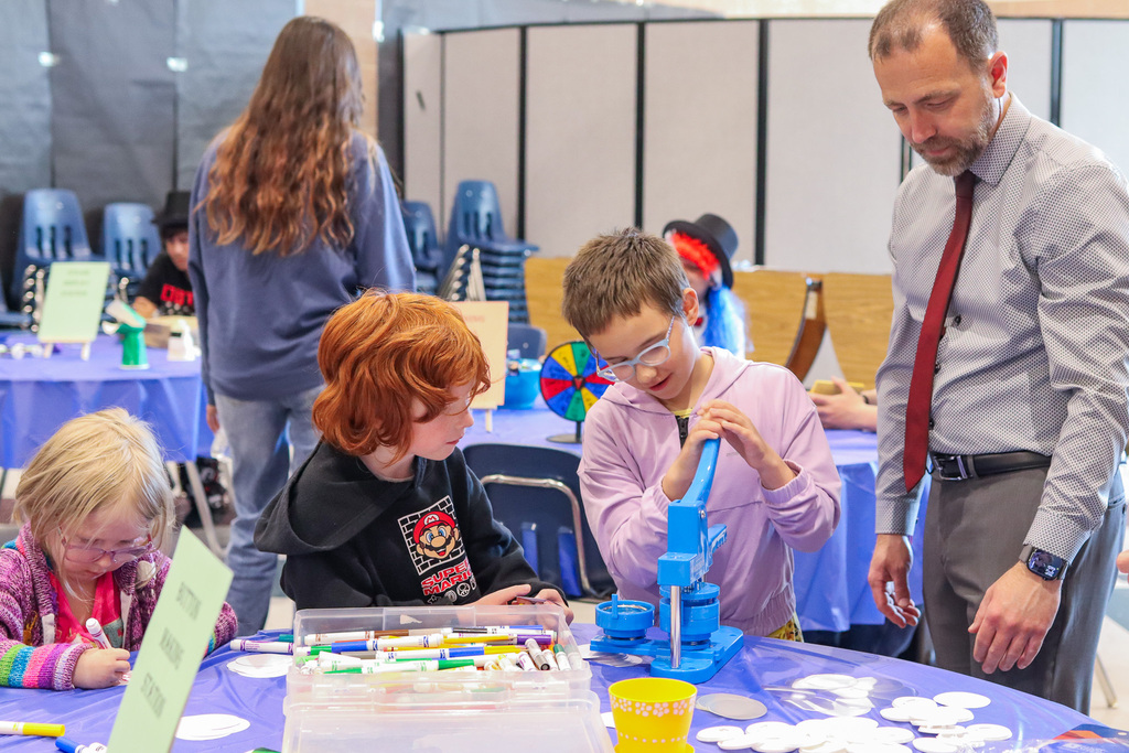 CBMS Principal Cotterell showing students how to make buttons 