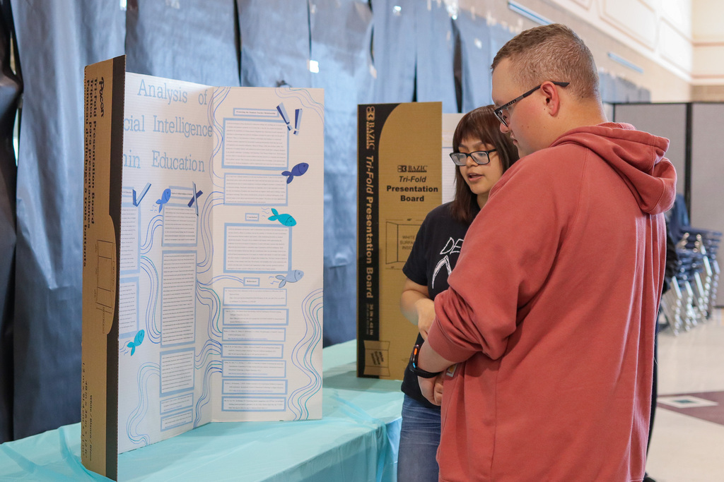 Intro to education student showing presentation to attendee 