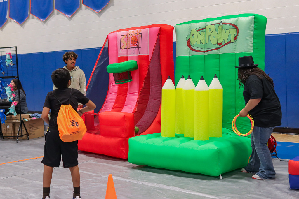 Student participating in fun ring toss carnival game 
