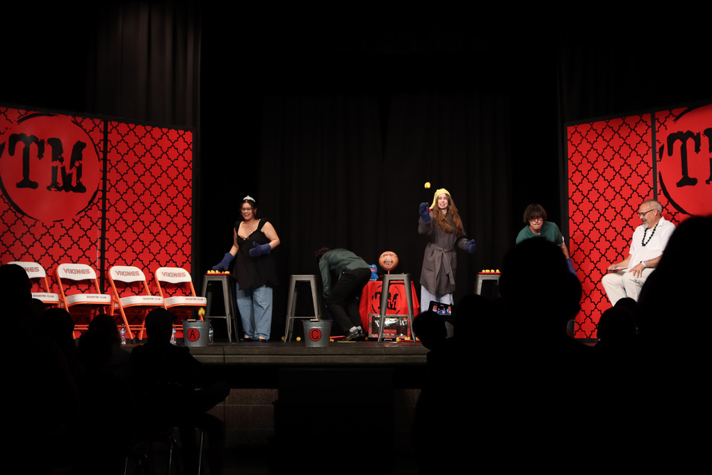 Students throwing rubber ducks into buckets