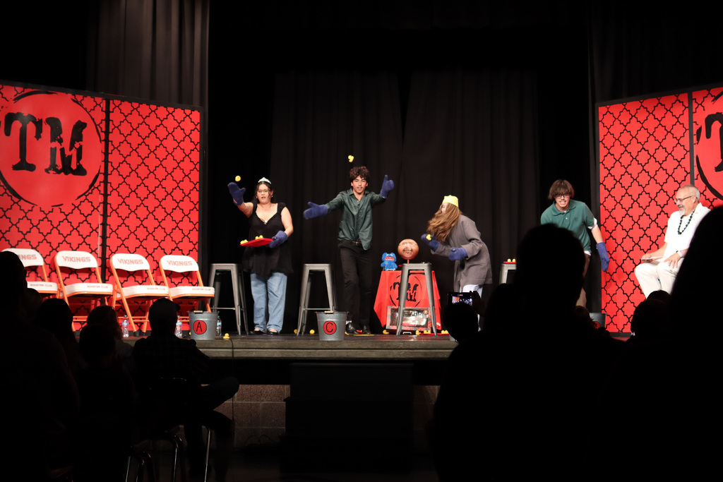 Students throwing rubber ducks into buckets