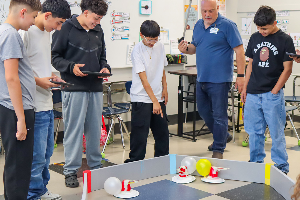 students driving their battle bots