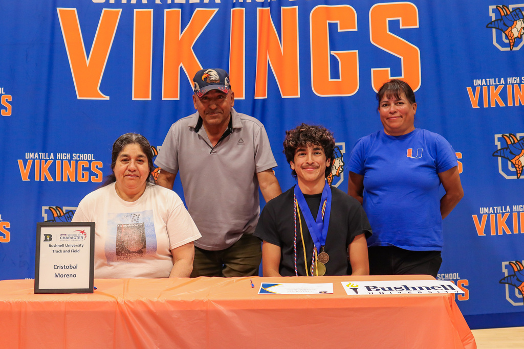 Senior Cristobal with family and coach