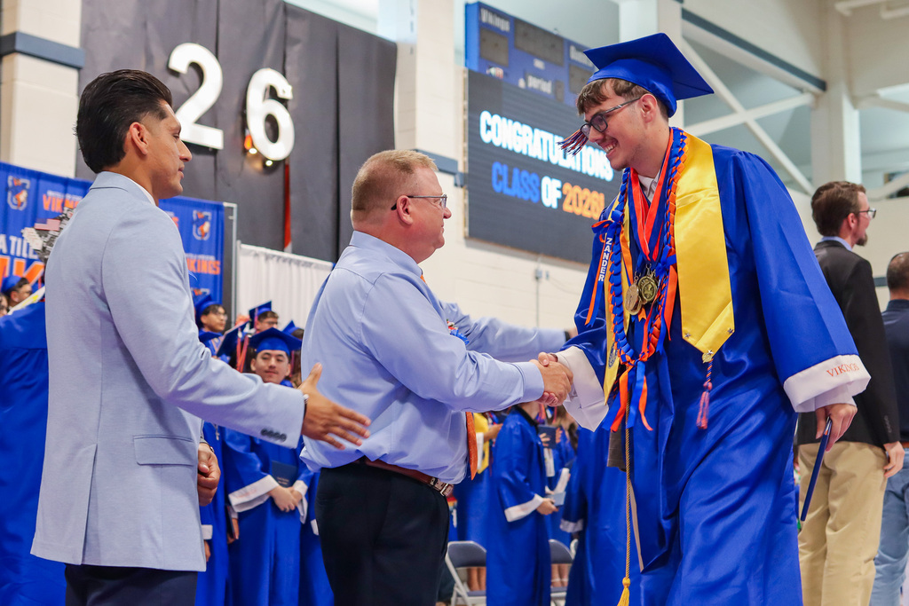 Student shaking hands with Principal Lorence
