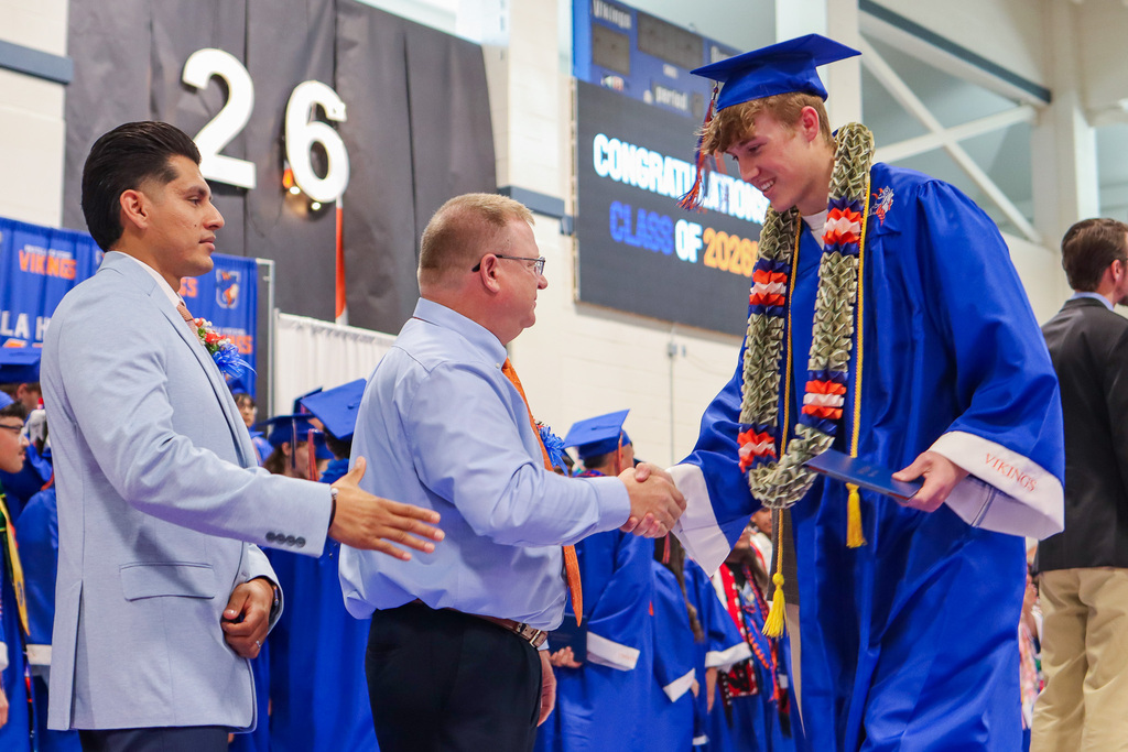 Student shaking hands with Principal Lorence