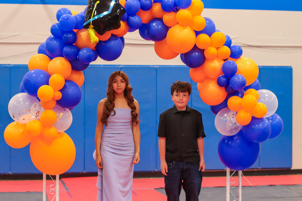 Students standing under balloon arch